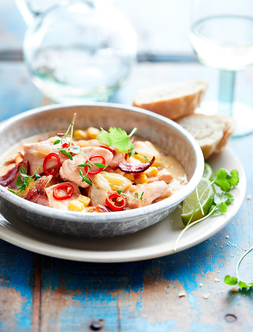 Sweet corn chowder with salmon and crisp shredded bacon