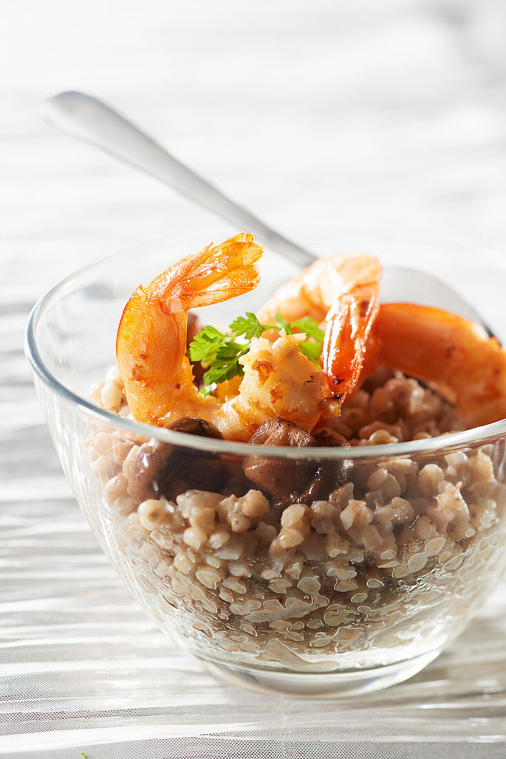 Buckwheat risotto with button mushrooms and prawns flambéed with pastis breton