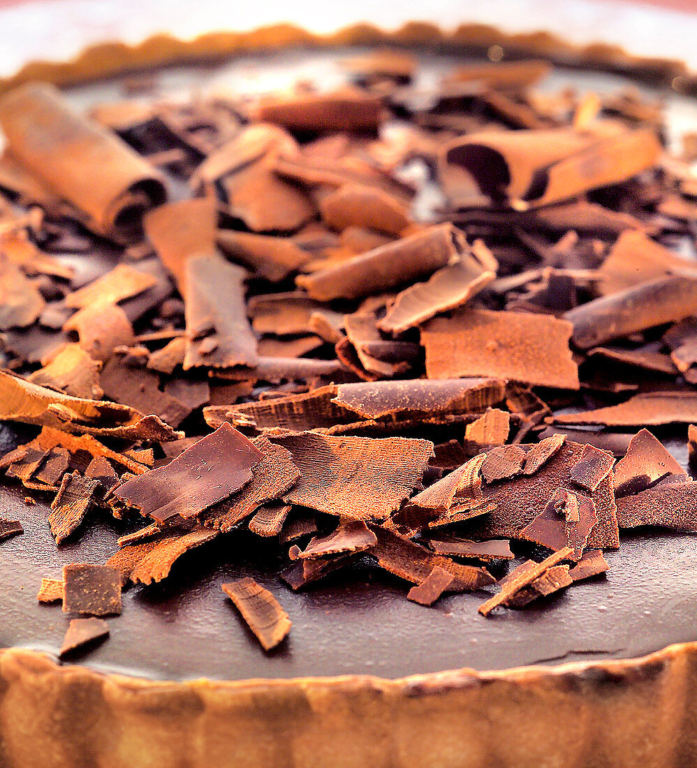 Chocolate flakes topping a chocolate tart