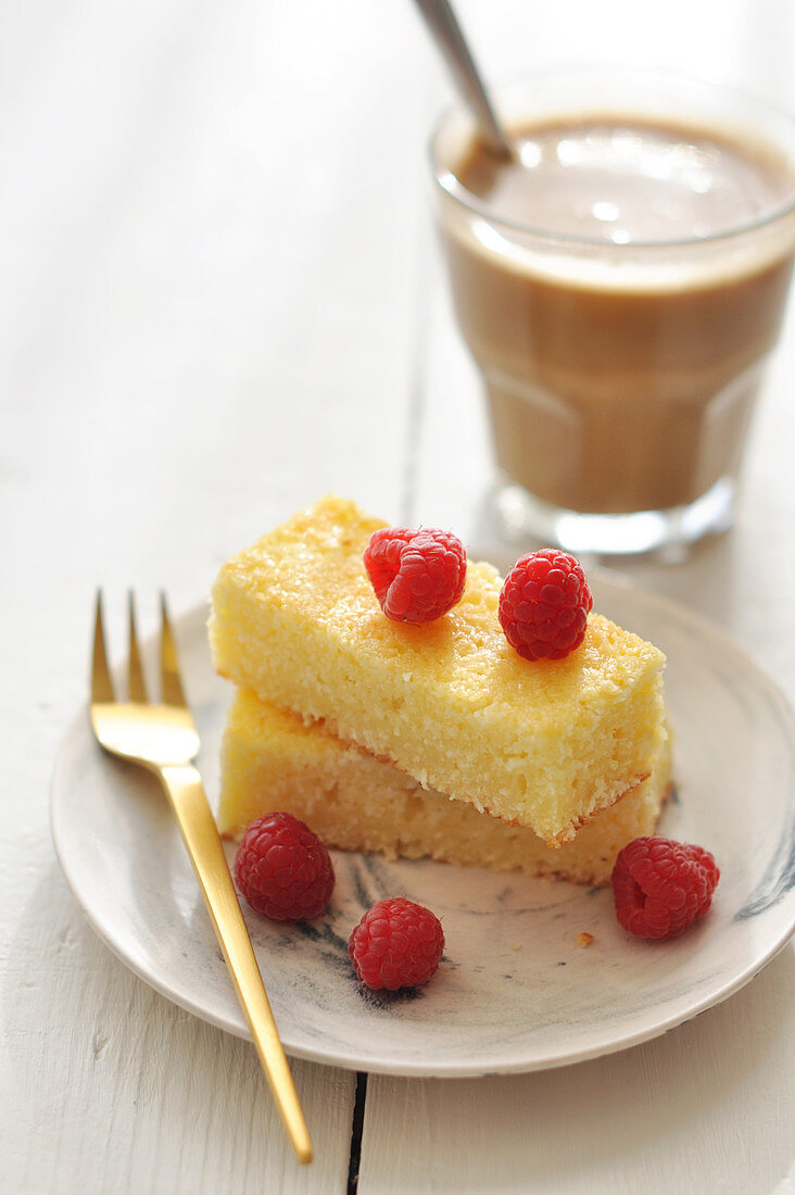 Coconut cake topped with fresh raspberries