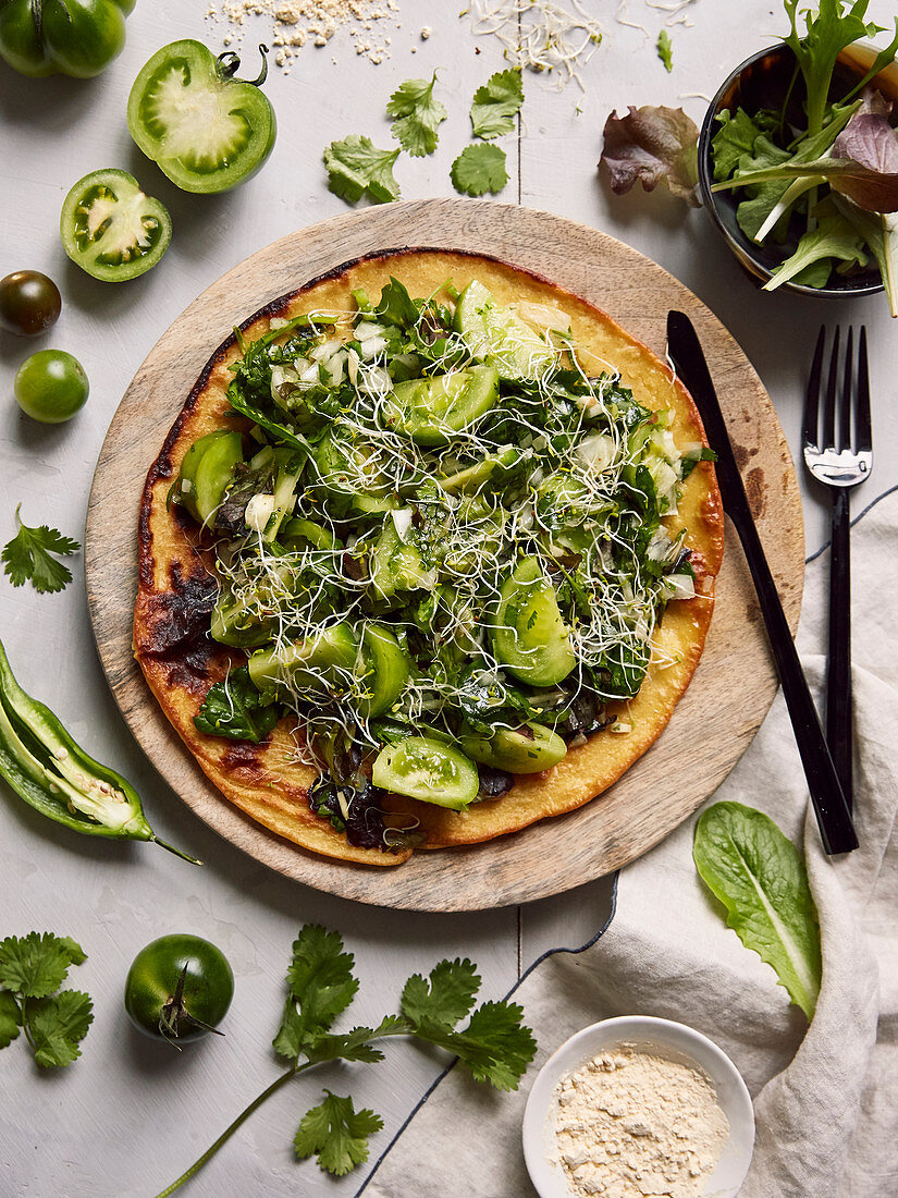 Chickpea flour pizza garnished with salsa verde