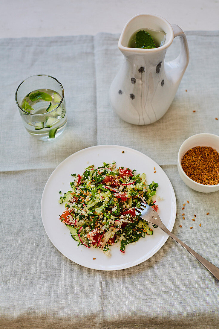 Salad with cucumber, radish, tomatoes, mint and roasted sesame seeds (vegan)