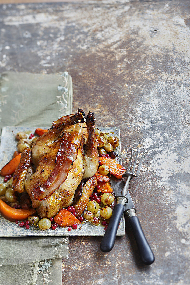 Roasted guinea-fowl with white grapes,cranberries and pumpkin