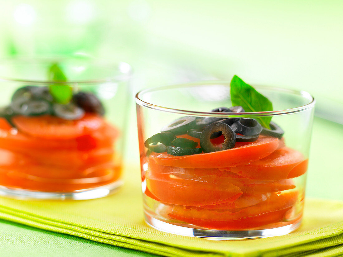 Glasses of tomato,black olive and basil salad