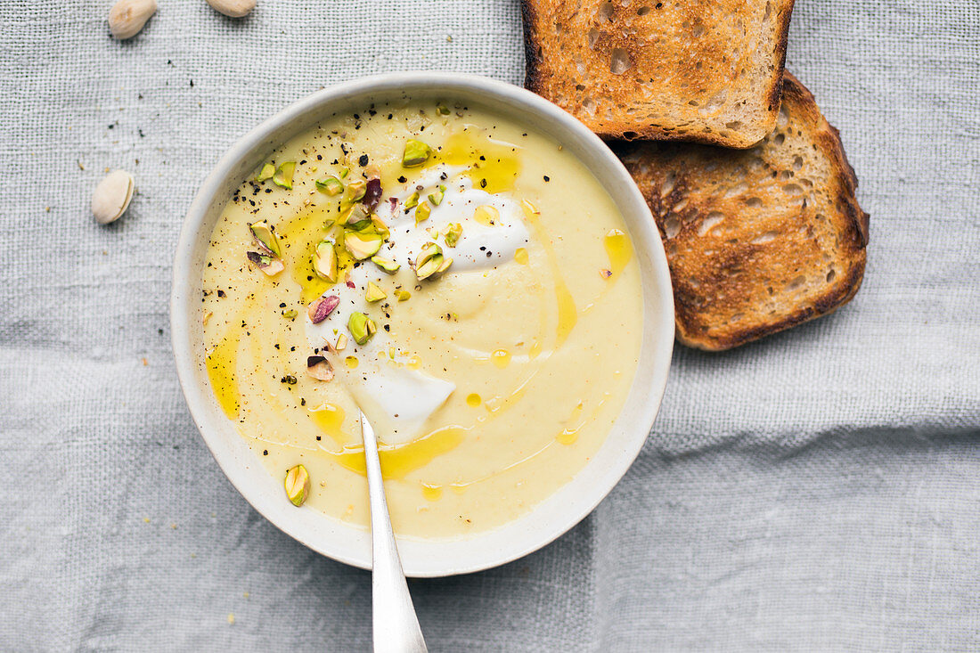 Cream of cauliflower and parsnip soup with pistachio chips
