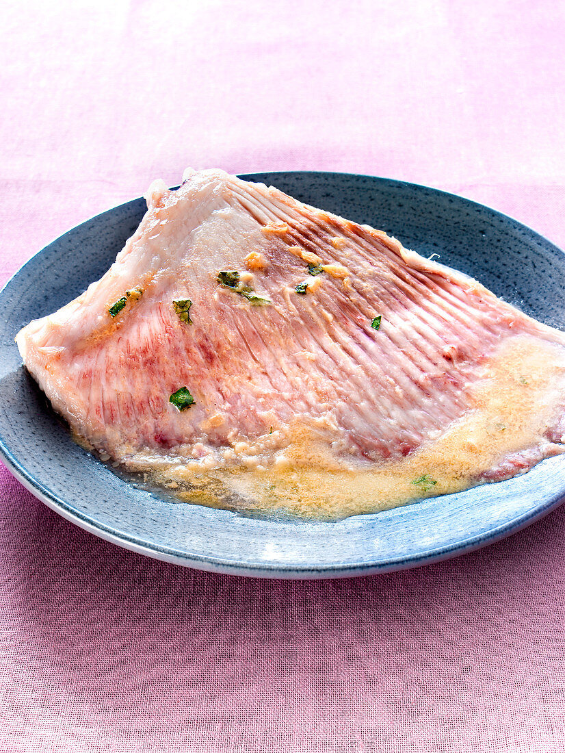 Skate cooked in a casserole with coriander and shallots