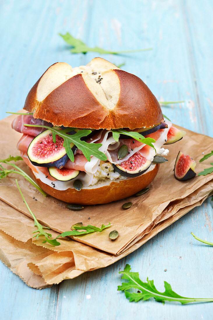 Fig, raw ham, brocciu and squash seed bretzel bread bun burger