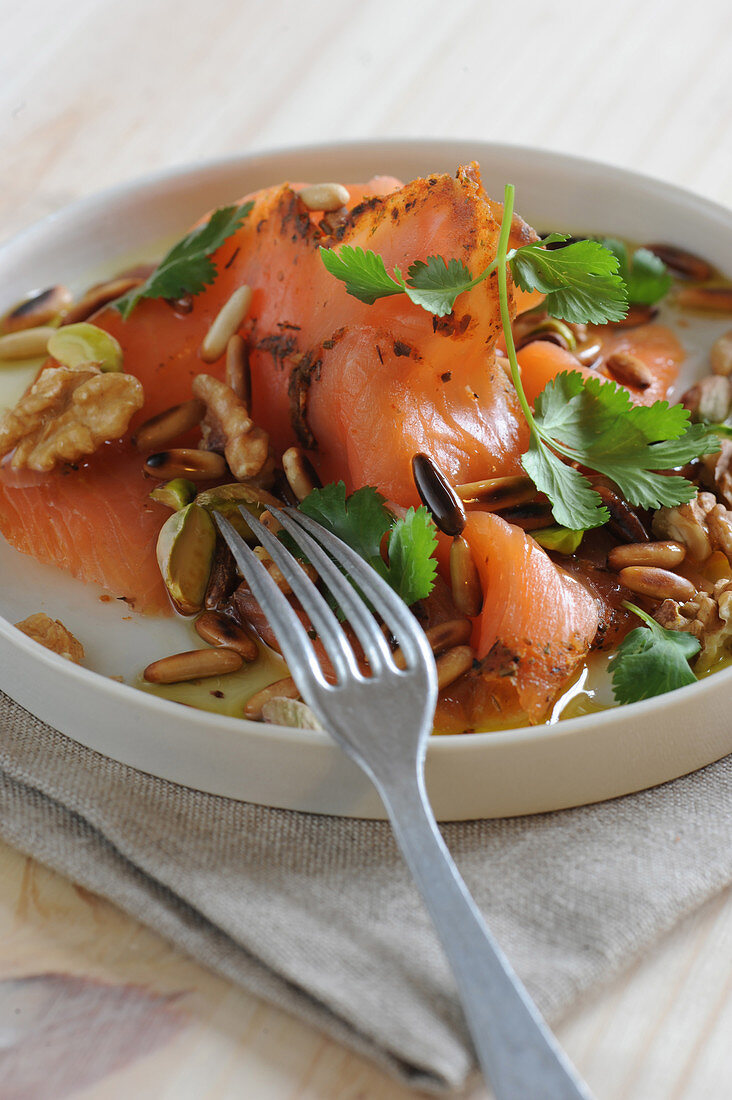 Thinly sliced smoked salmon with crunchy dried fruit