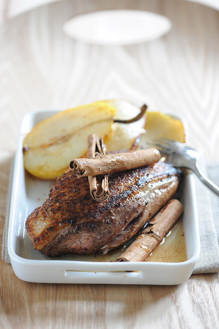 Duck breast cooked with cider and spices,roasted pears