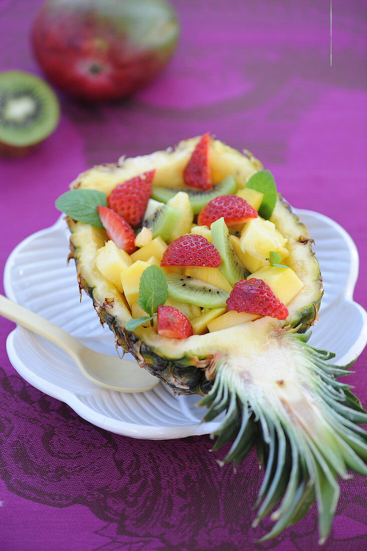 Exotic fruit salad served in a pineapple skin