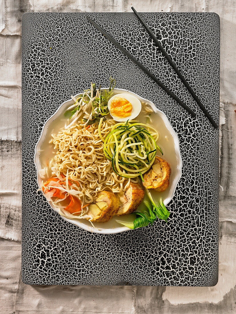 Ramen broth with vegetables,eggs and chicken Ballotine with apple
