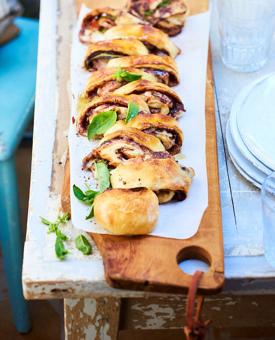 Stuffed bread roulade with tapenade, bacon and mozzarella cheese
