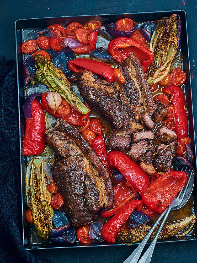 Oven-baked beef brisket with spices, sucrines, red peppers and tomatoes