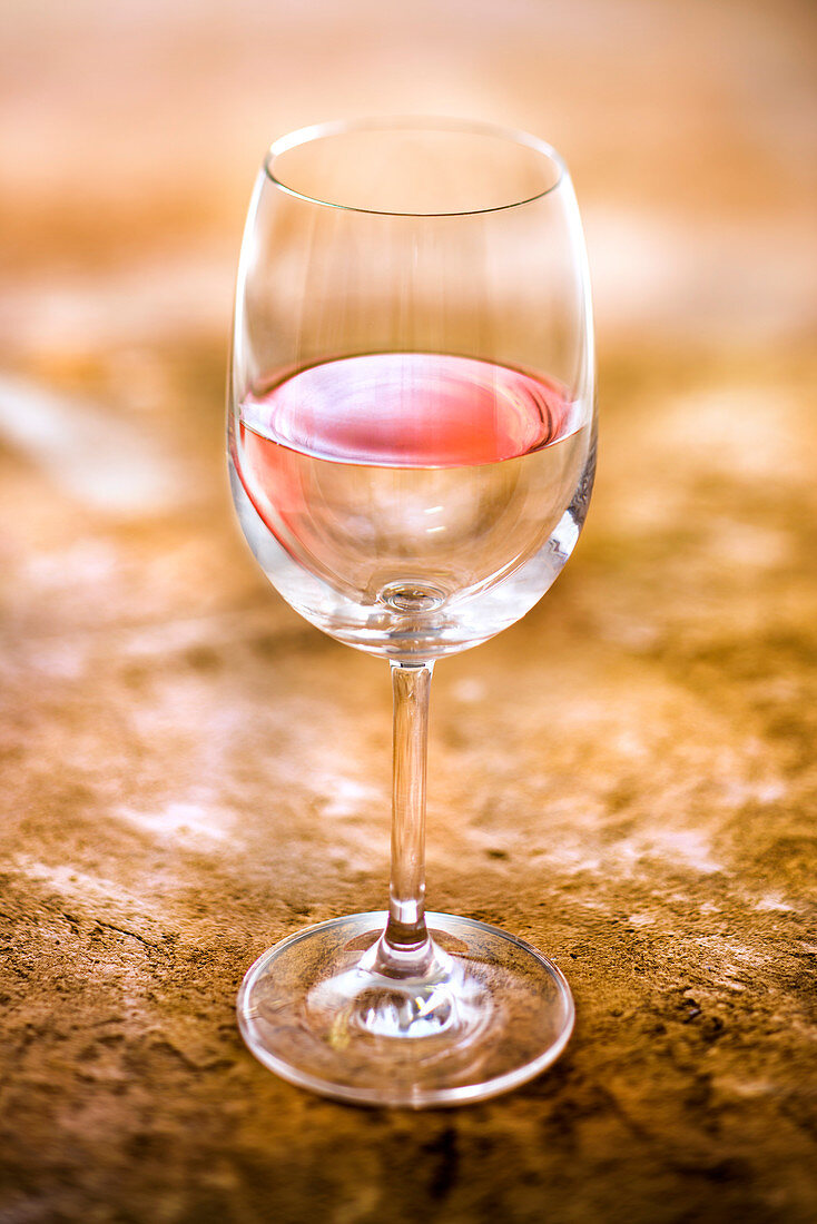 Illusion of a glass of rosé wine and water