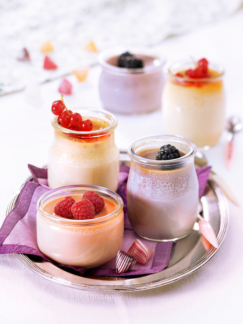 Small pots of different-flavored cream desserts