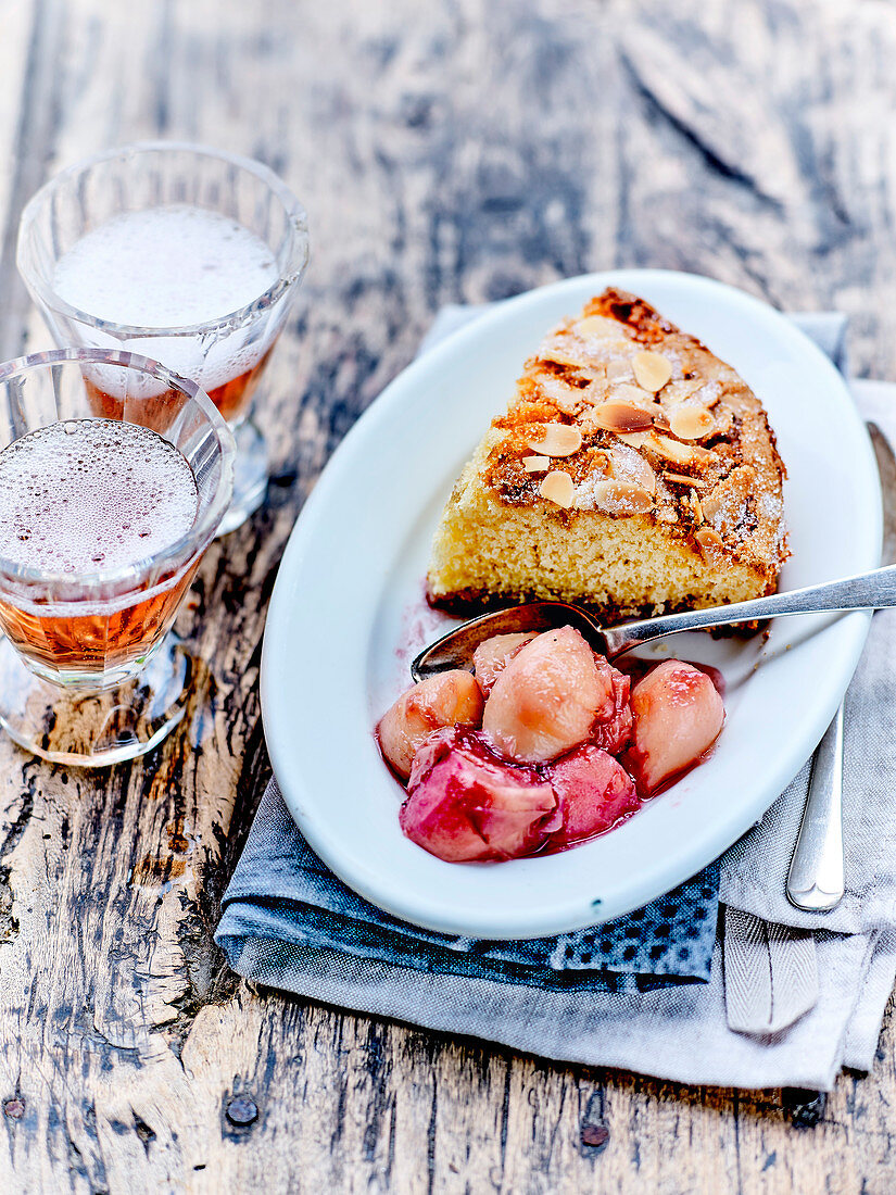 Soft almond cake with wild peaches stewed with balsamic vinegar and rosemary