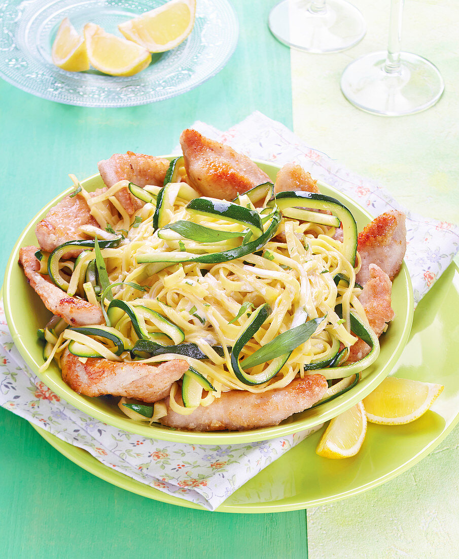 Tagliatelles in creamy sauce with courgettes and thinly sliced turkey fillets