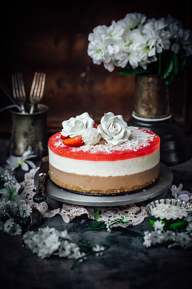 Anzac cookie crust, chocolate, coconut and strawberry jelly cheesecake