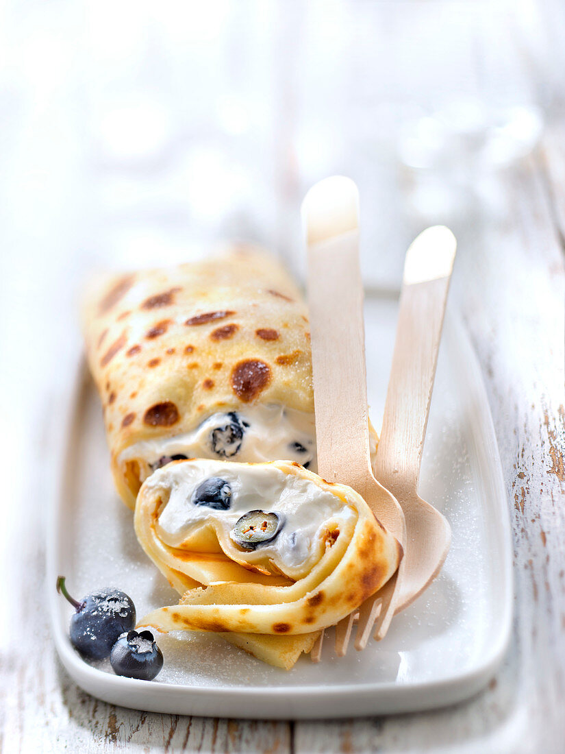 Blintzes,rolled pancakes garnished with fromage blanc and blueberries