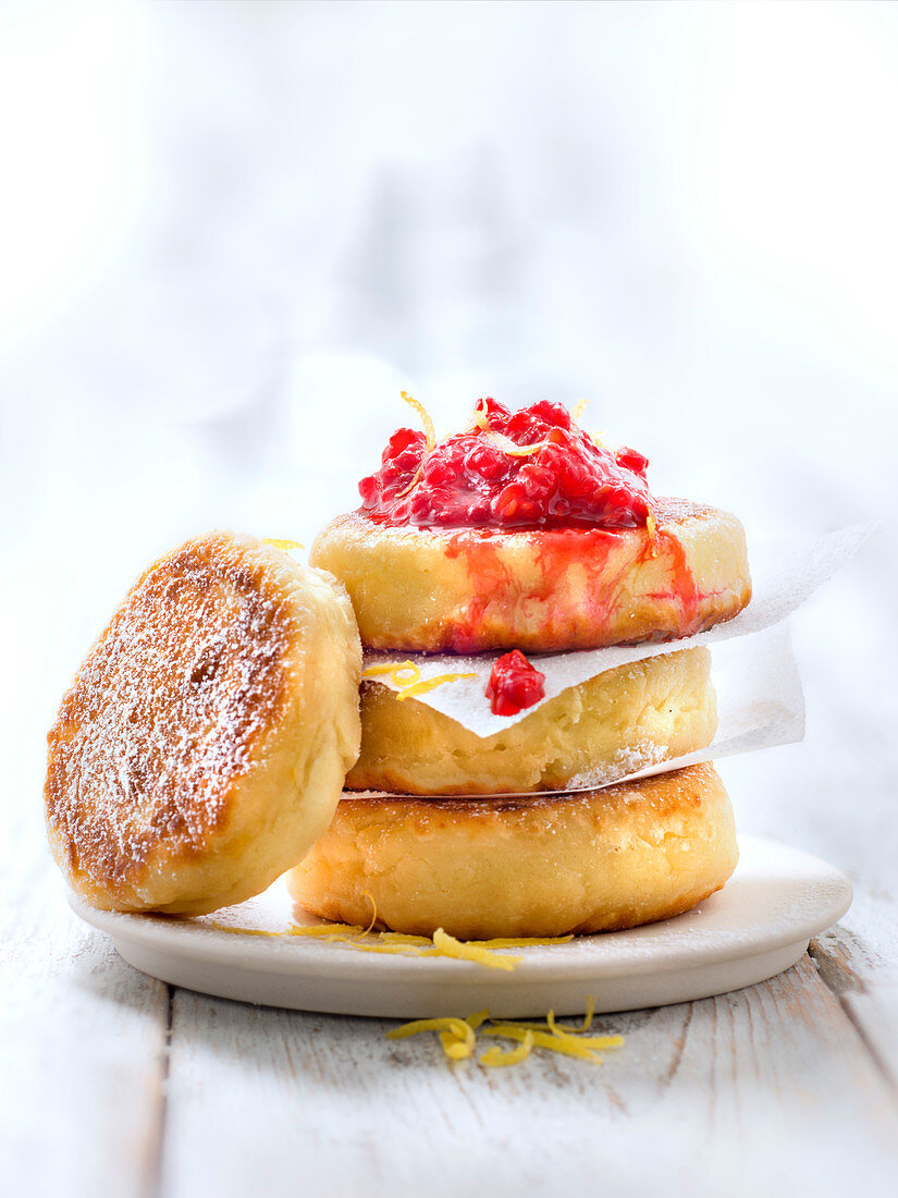 Syrniki,thick fromage blanc galettes with stewed raspberries