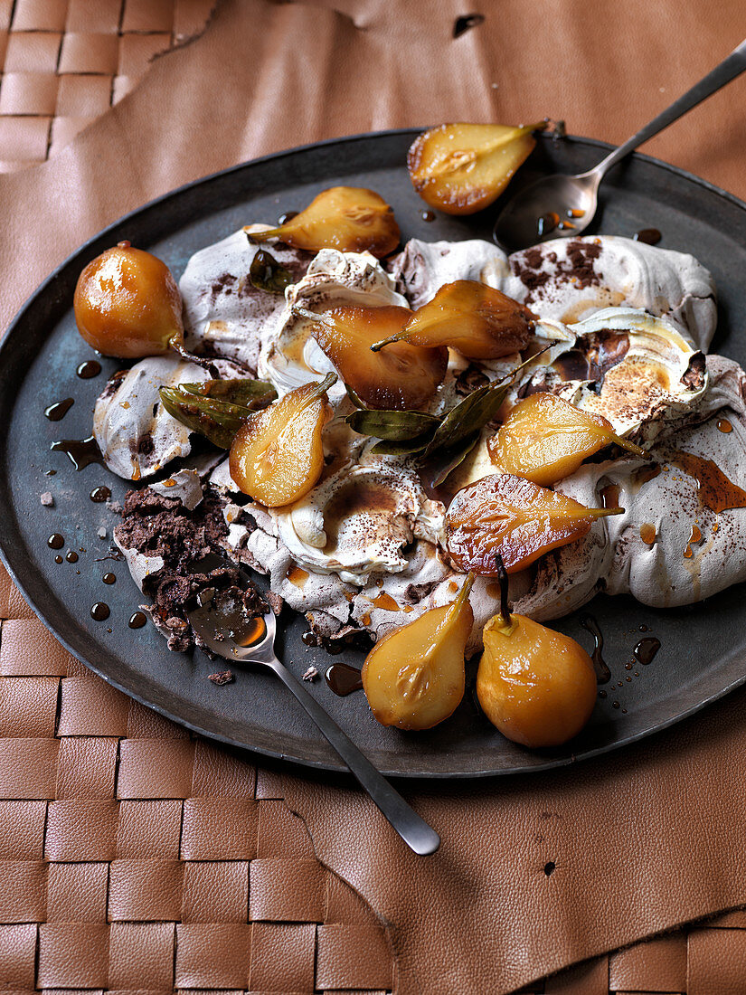 Pavlova with small pears poached with spices, maple syrup and bay leaves
