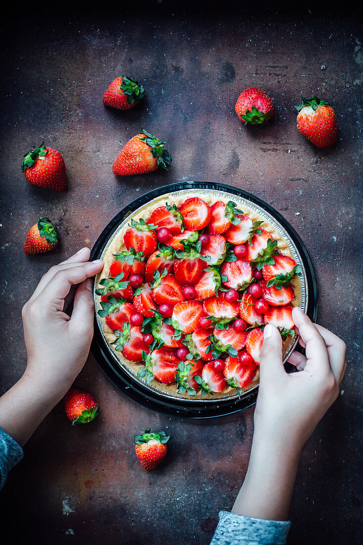 Hands Preparing Strawberry Tart