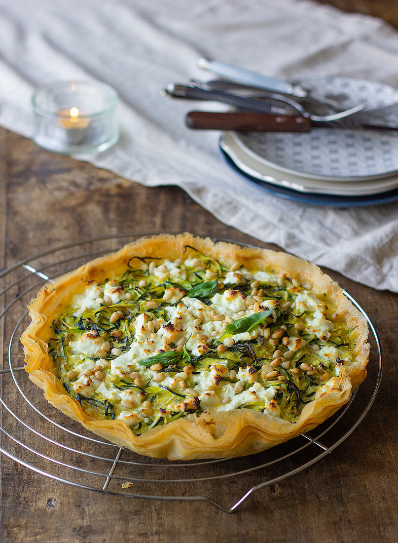 Crispy zucchini pie with fresh goat cheese and toasted pine nuts