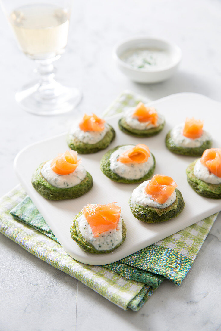 Blinis Garnished With Spinach,Cream And Smoked Salmon