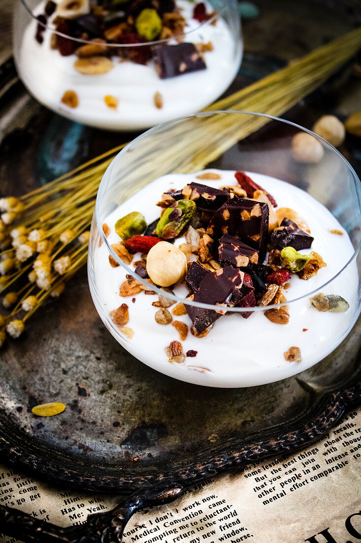 Glasses Of Fromage Blanc With Crunchy Granola,Goji Beans And Dark Chocolate