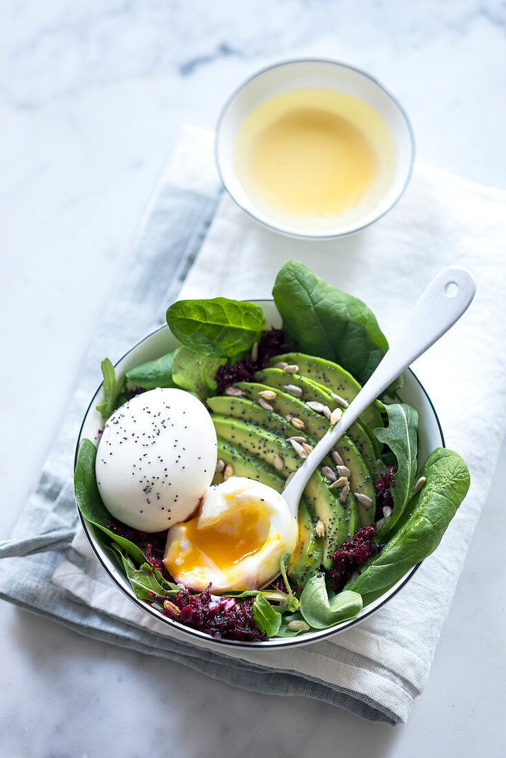 Avocado salad with spinach, rocket, beetroot, egg, poppy seeds and sunflower seeds