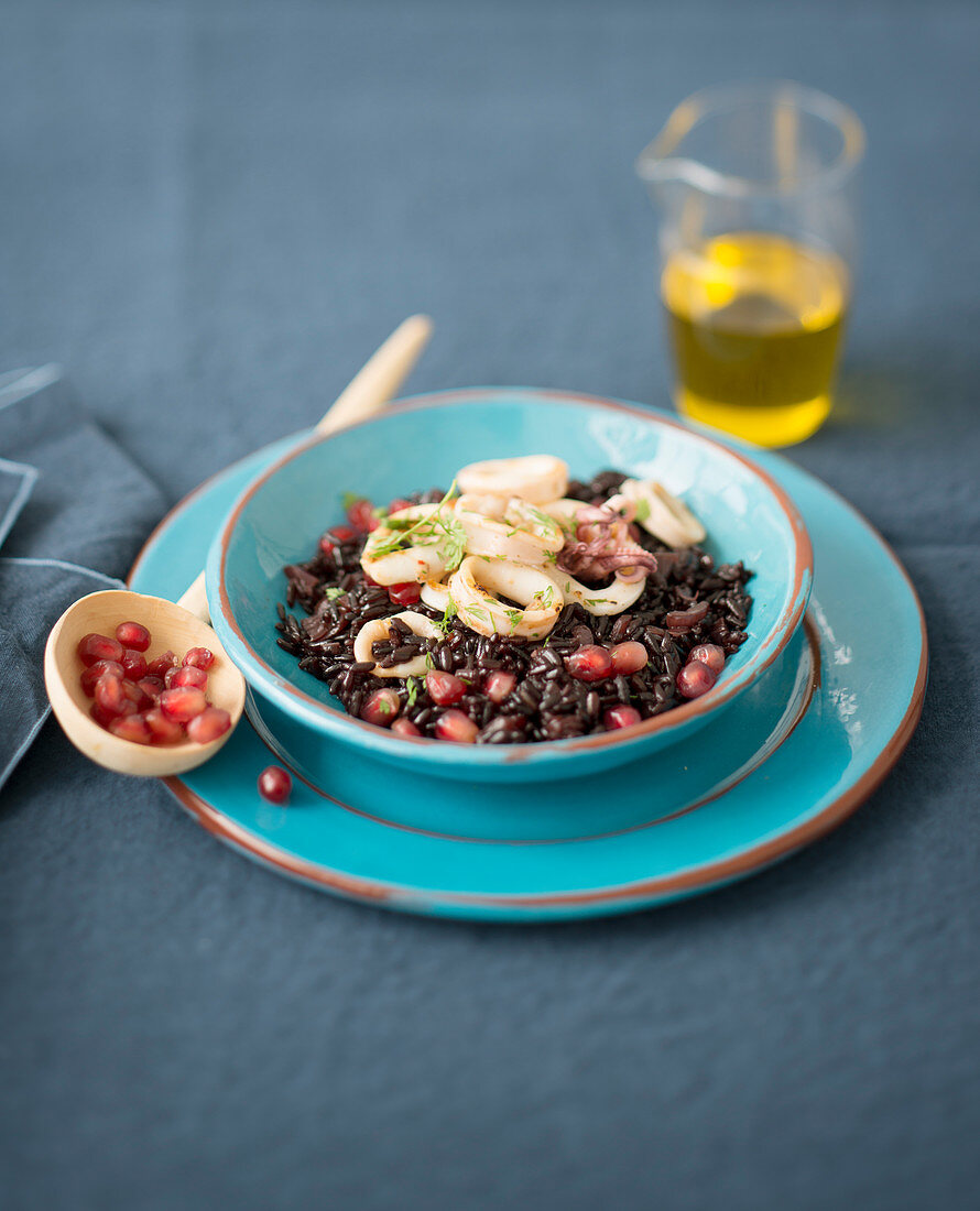 Black rice with squid and pomegranate seeds