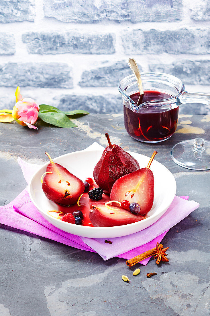 Pears poached in red wine and spices, summer fruit and orange zests