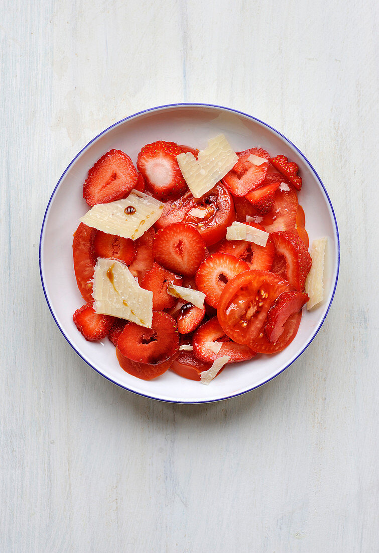 Tomato and strawberry salad with parmesan flakes