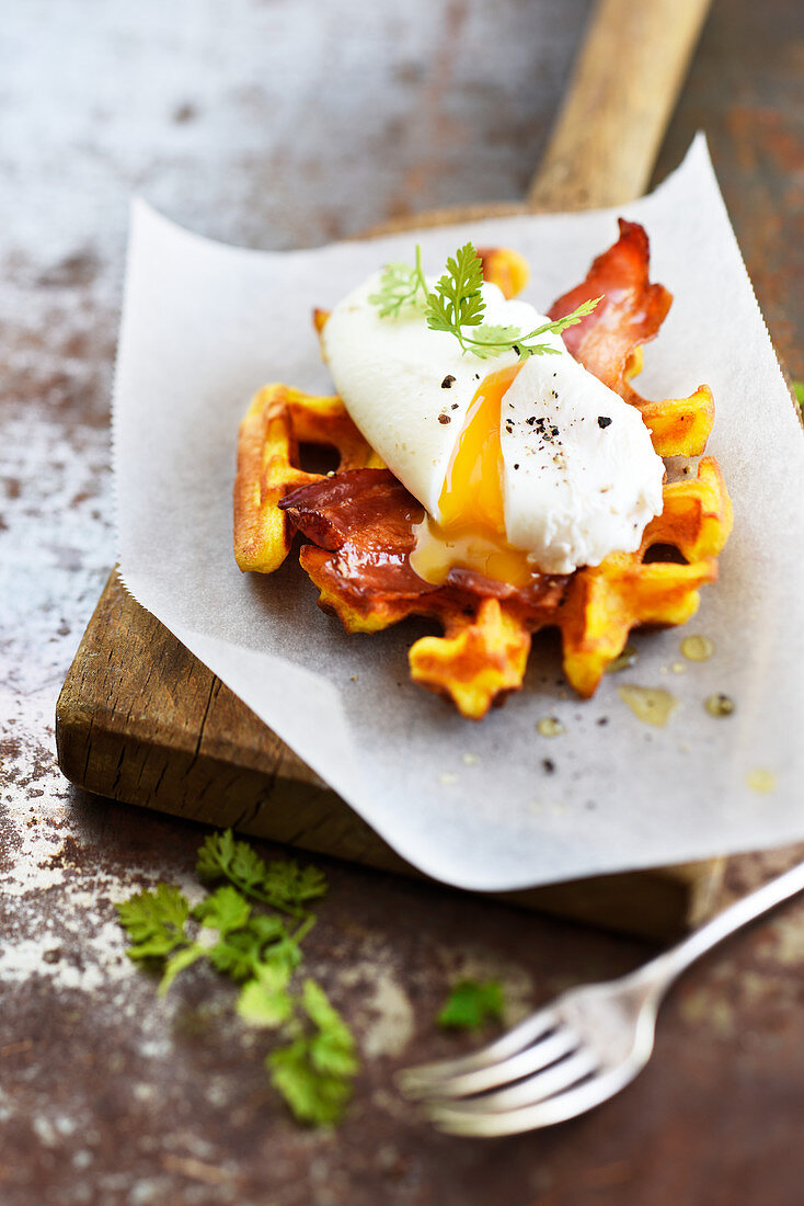 Pumpkin waffle with crisp bacon and poached egg