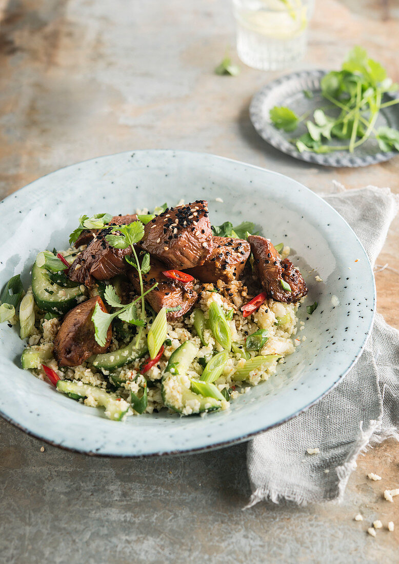 Teriyaki chicken on semolina with cucumber and spring onions