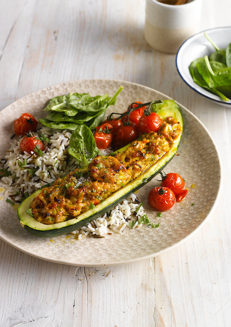 Courgette half stuffed with chicken mince served with rice and tomatoes