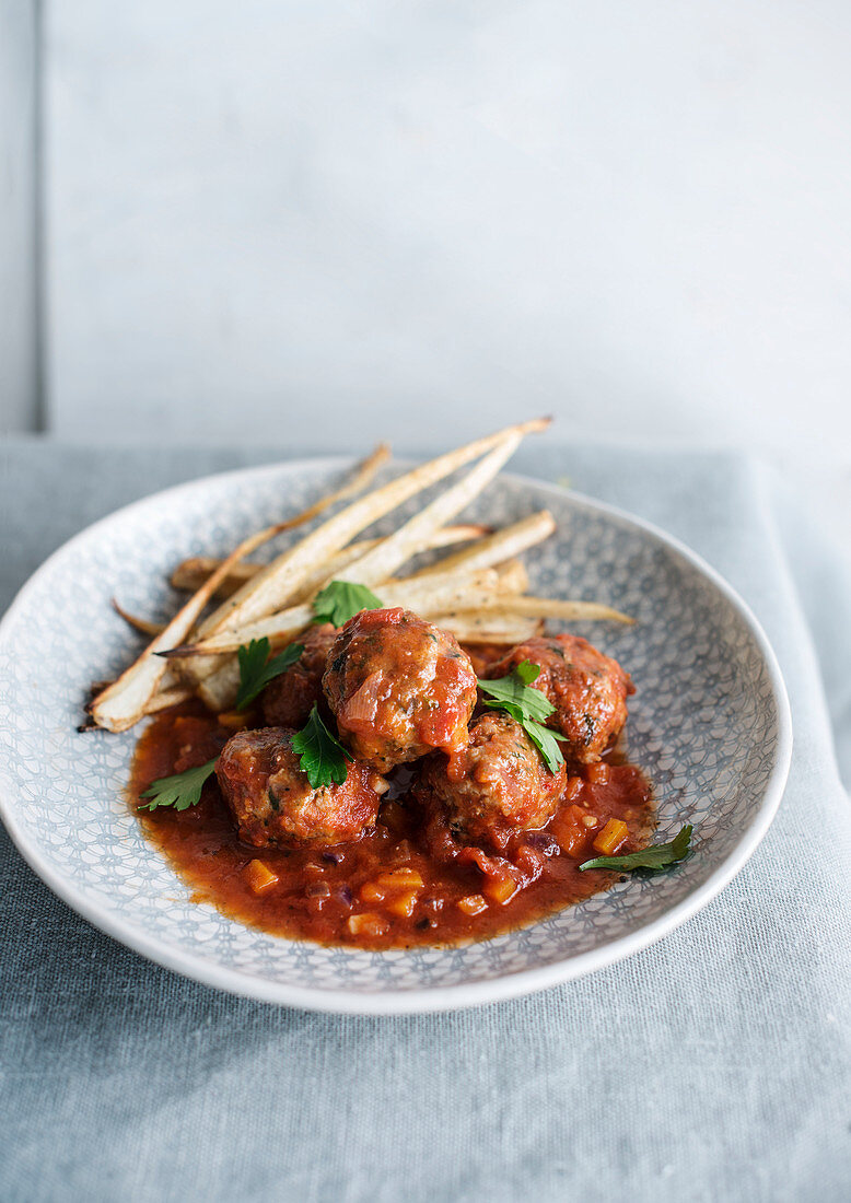 Meatballs with tomato sauce and parsnip fries