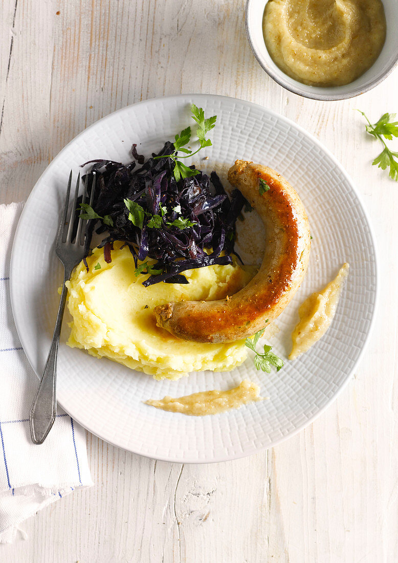 Bratwurst with red cabbage salad and mashed potatoes