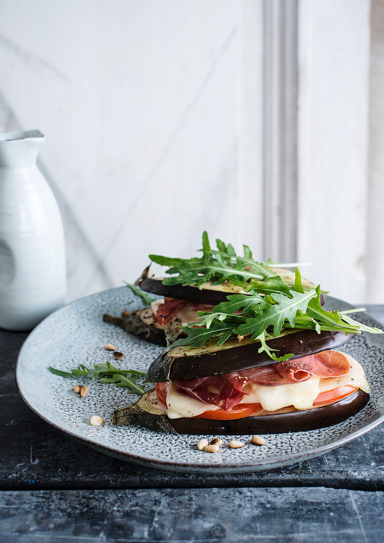 Aubergines with tomatoes, ham and melted cheese