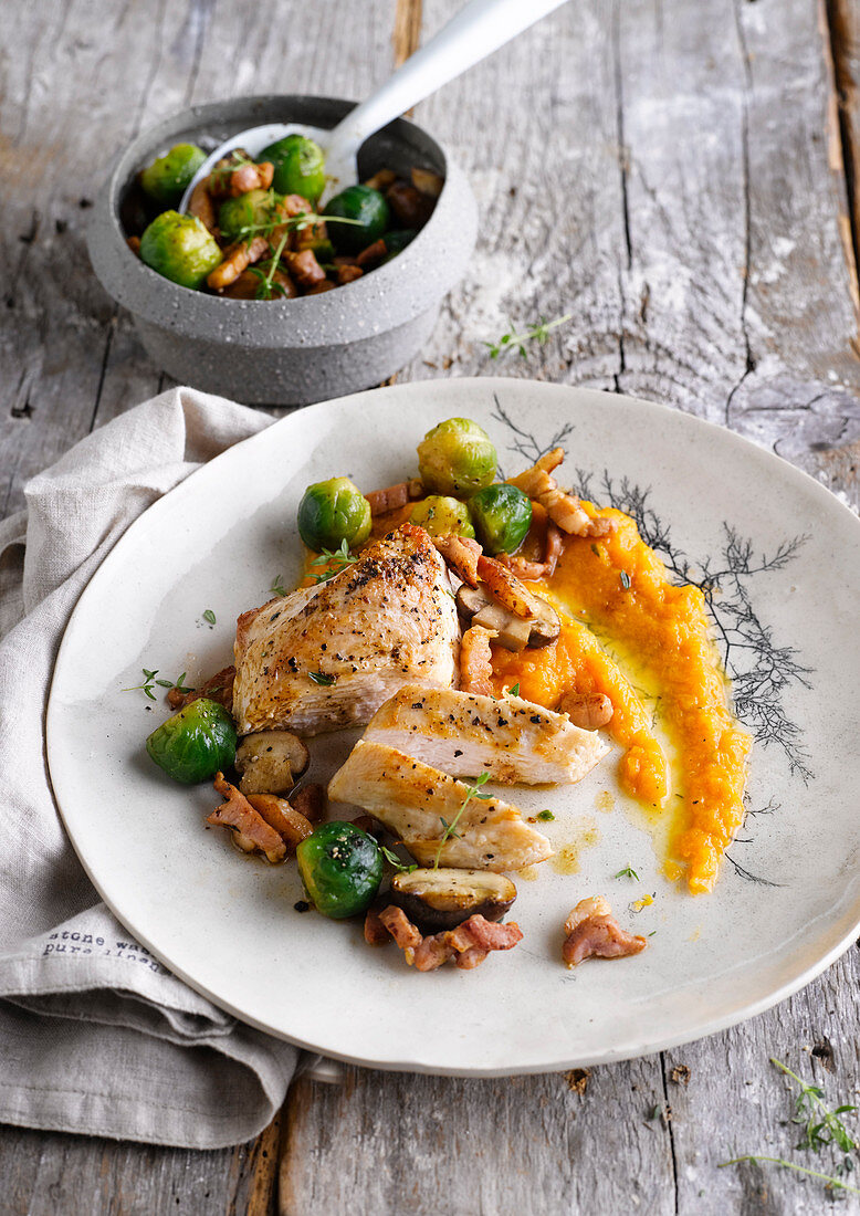 Chicken breast with carrot puree, Brussels sprouts, mushrooms and bacon