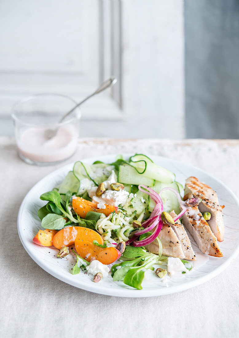 Grilled chicken breast with feta salad, courgettes and apricots