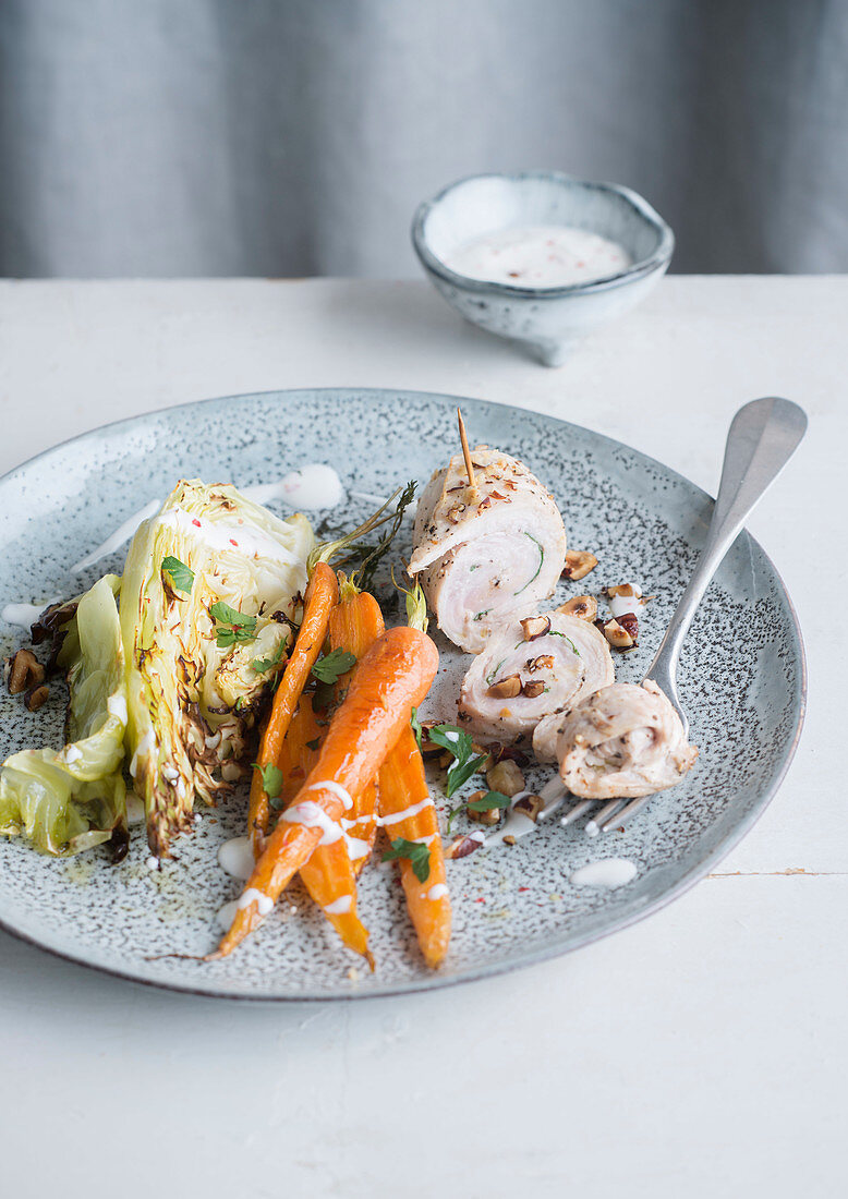 Chicken breast rolls with roasted cabbage and carrots