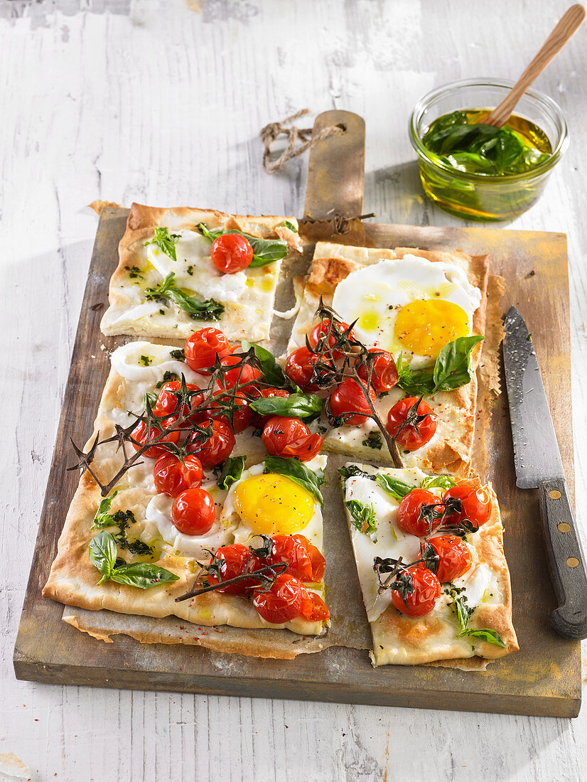 Pizza with eggs and cherry tomatoes