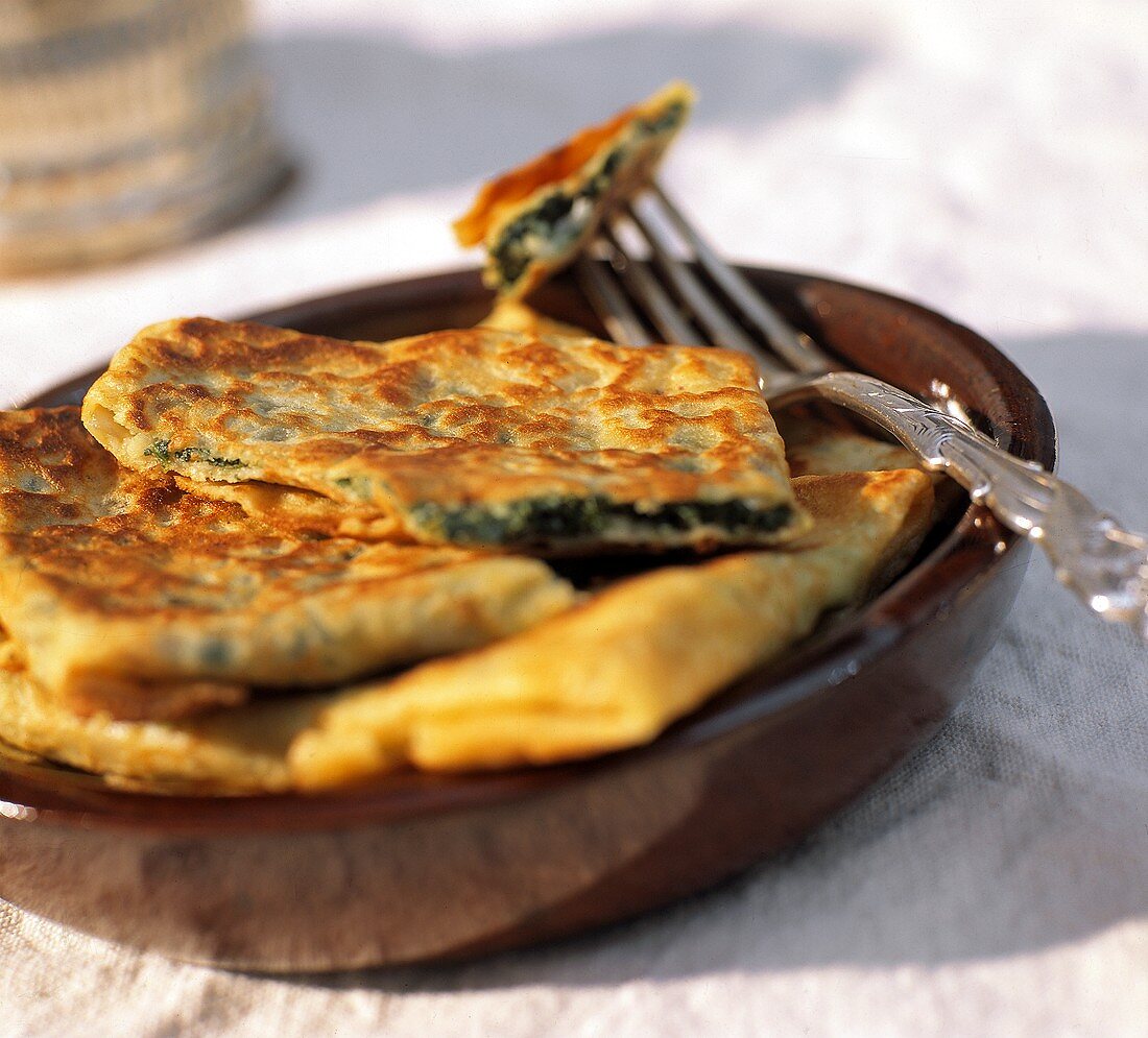 Spinach and Feta Crepes on a Brown Plate
