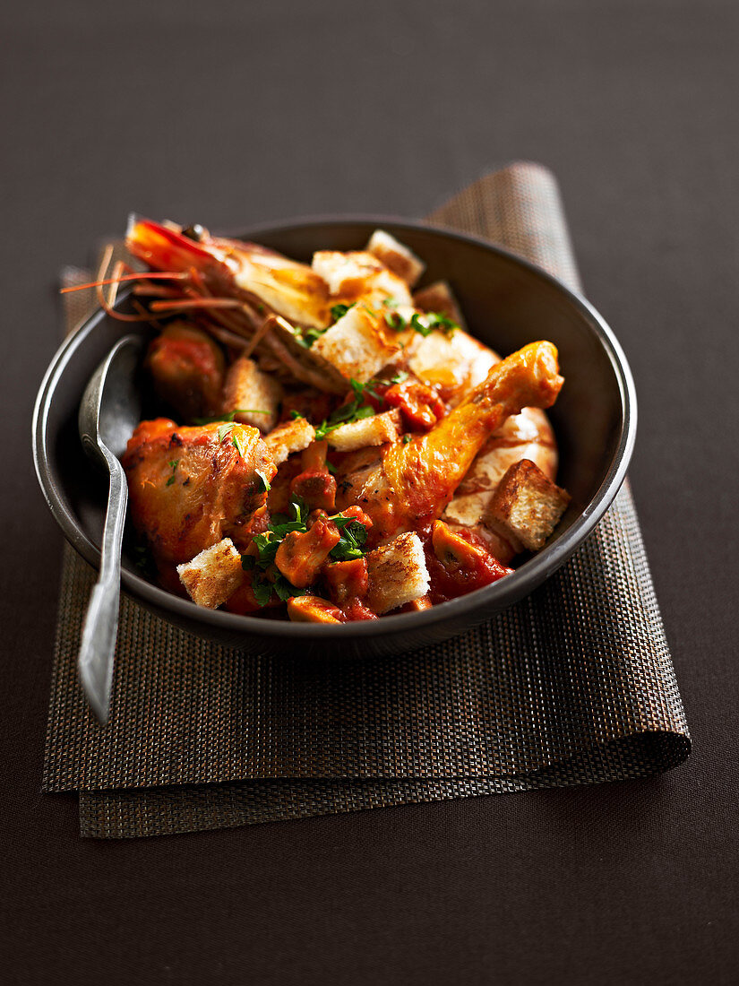 Chicken with gambas and mushrooms in tomato sauce