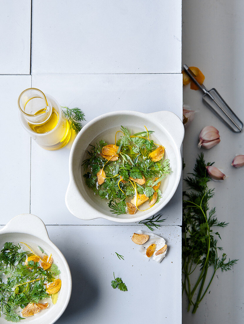 Broth with fresh herbs, garlic and orange zest