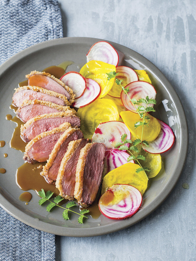 Duck breast with a walnut crust, served with yellow beetroot and chioggia