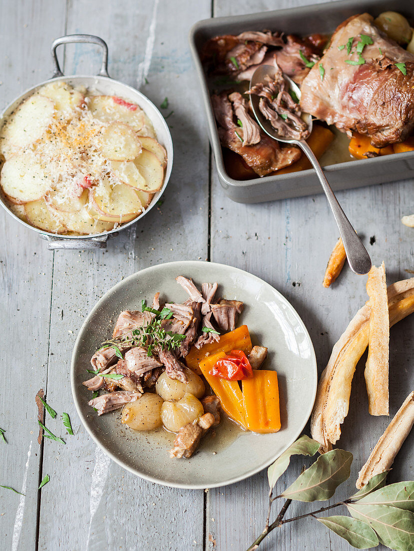 Lamb with carrots and onions and potato gratin