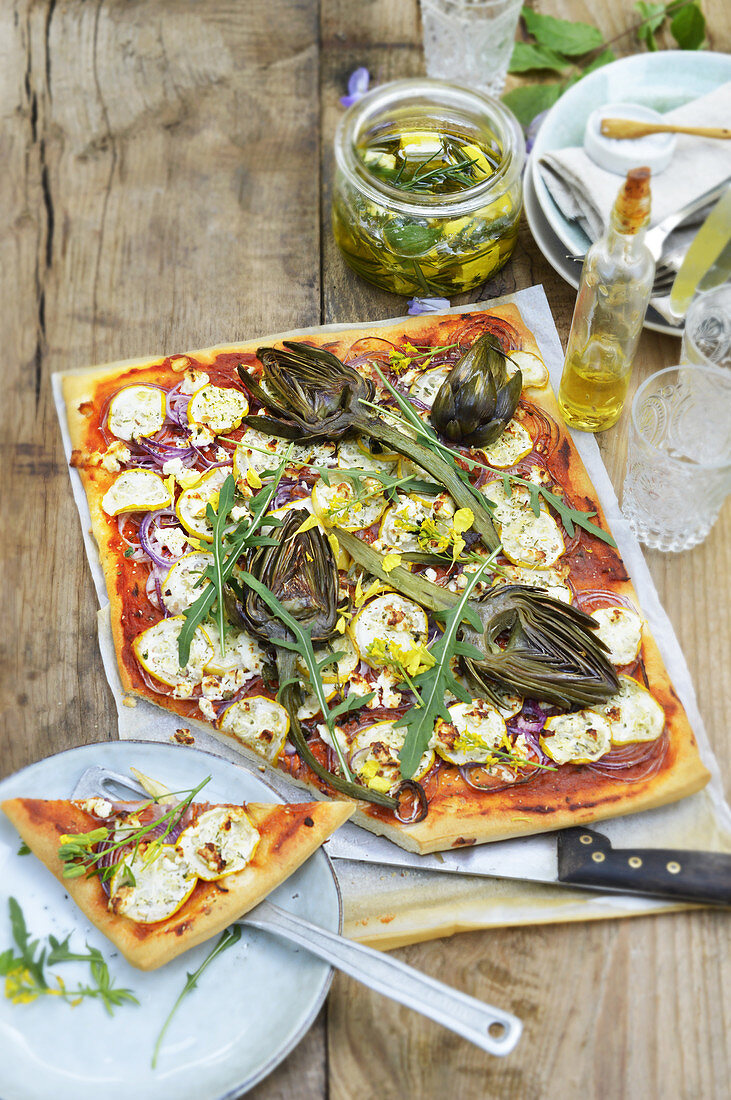 Summer vegetable pizza with courgette, artichokes and feta