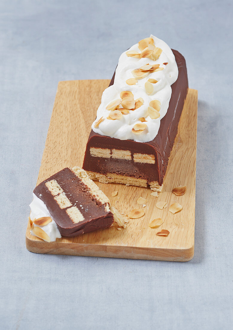 Chocolate terrine with biscuits, whipped cream and almonds